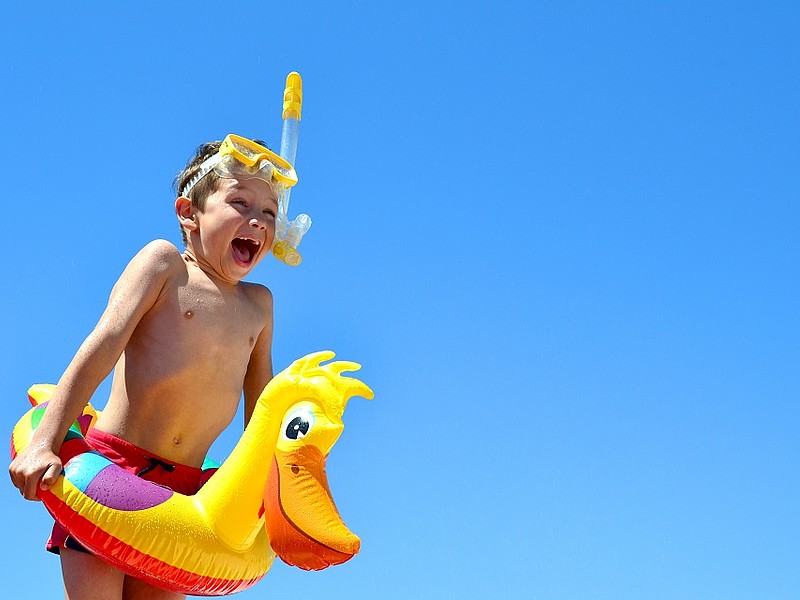 Kind mit Schwimmring und Taucherbrille