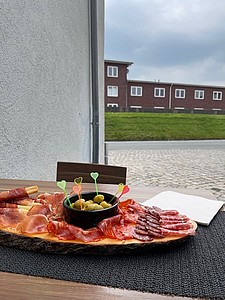 Platte mit Essen mit Ausblick auf einen Deich in Cuxhaven