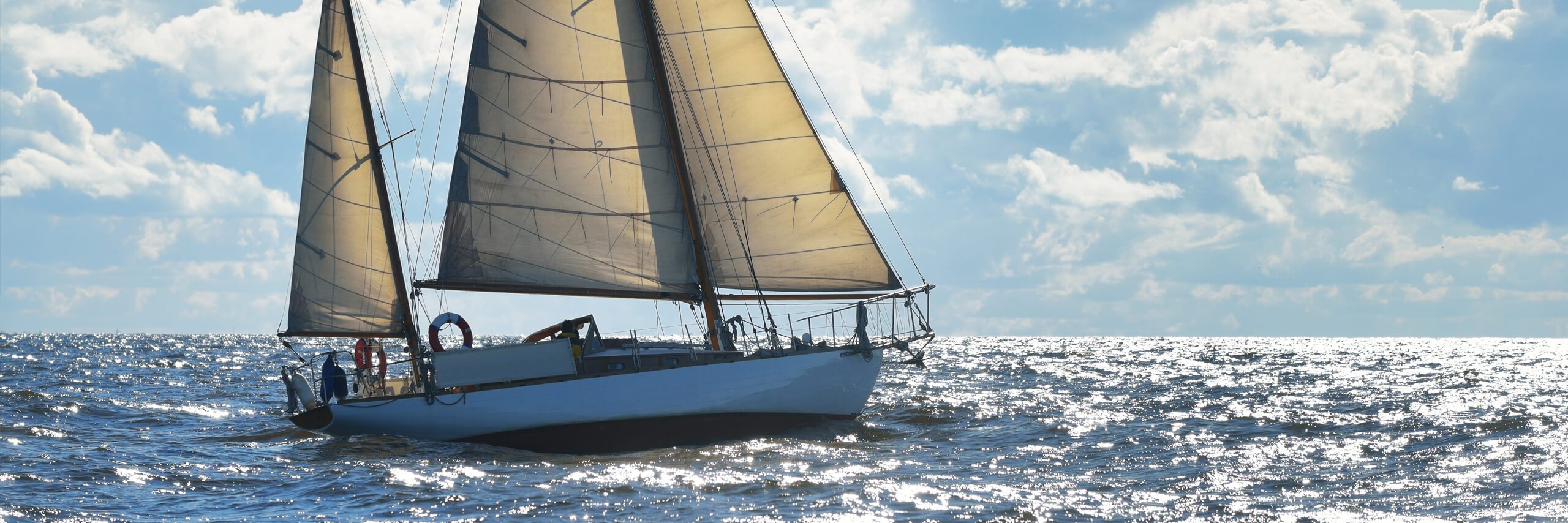 Segelschiff auf dem Meer bei Sonnenschein und blauem Himmel